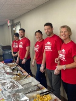 Picture of employees serving lunch to Veterans